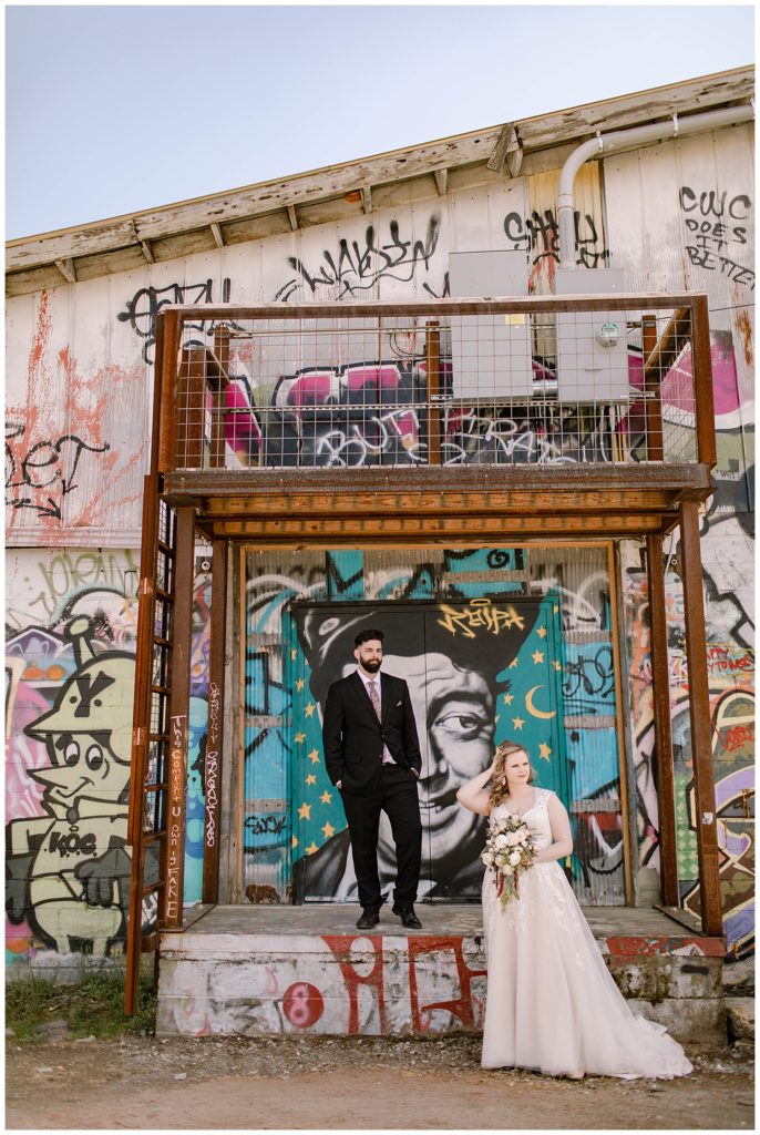 wedding photos in front of mural in asheville