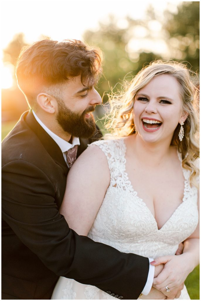 bride and groom laugh at sunset portraits