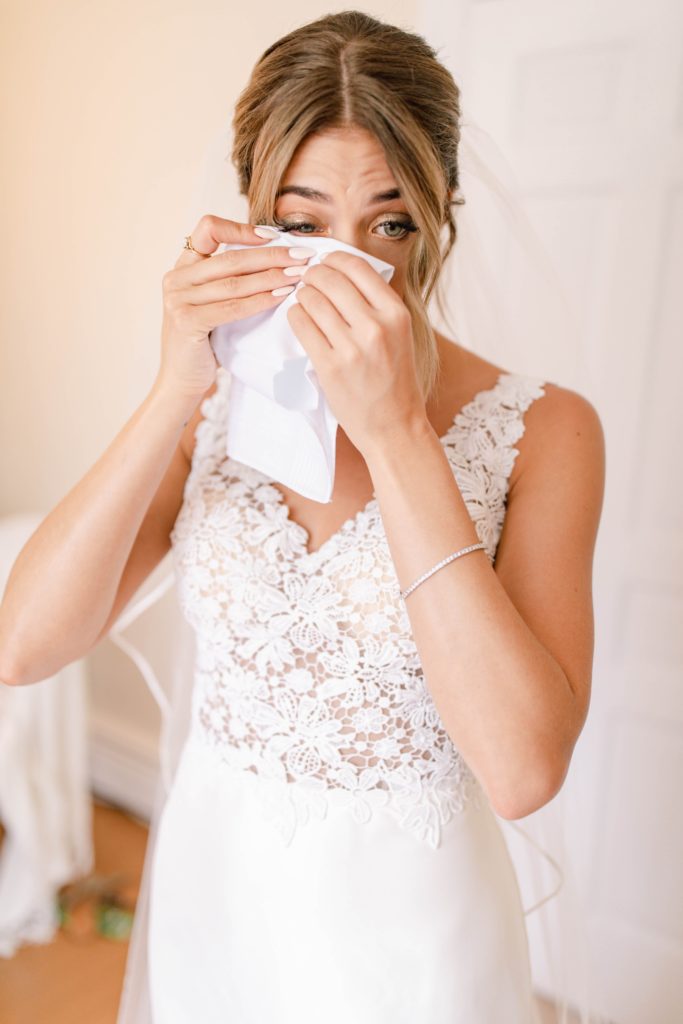 bride crying while getting ready