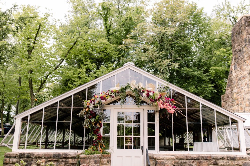 greenhouse at wedding covered in flowers