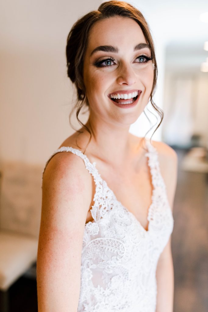 bride laughing while getting ready
