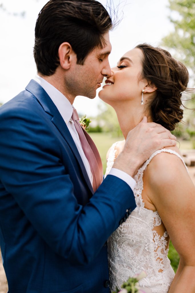 bride and groom kiss at wedding