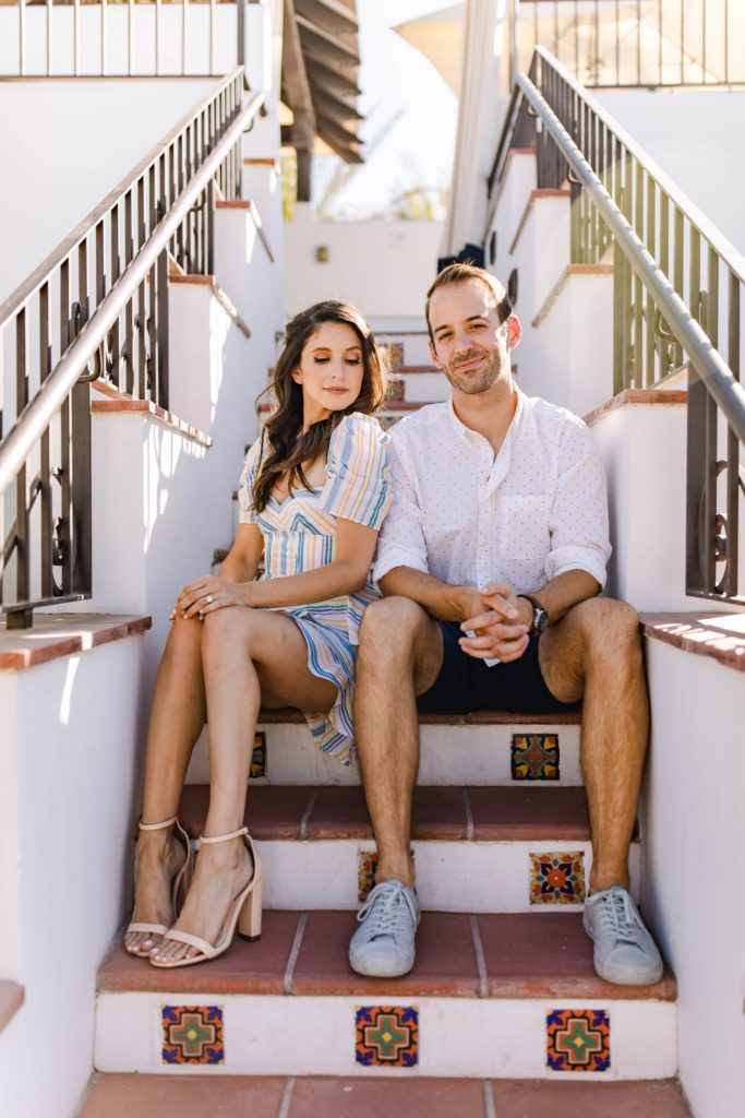 couple sitting on stairs at hotel in palm springs