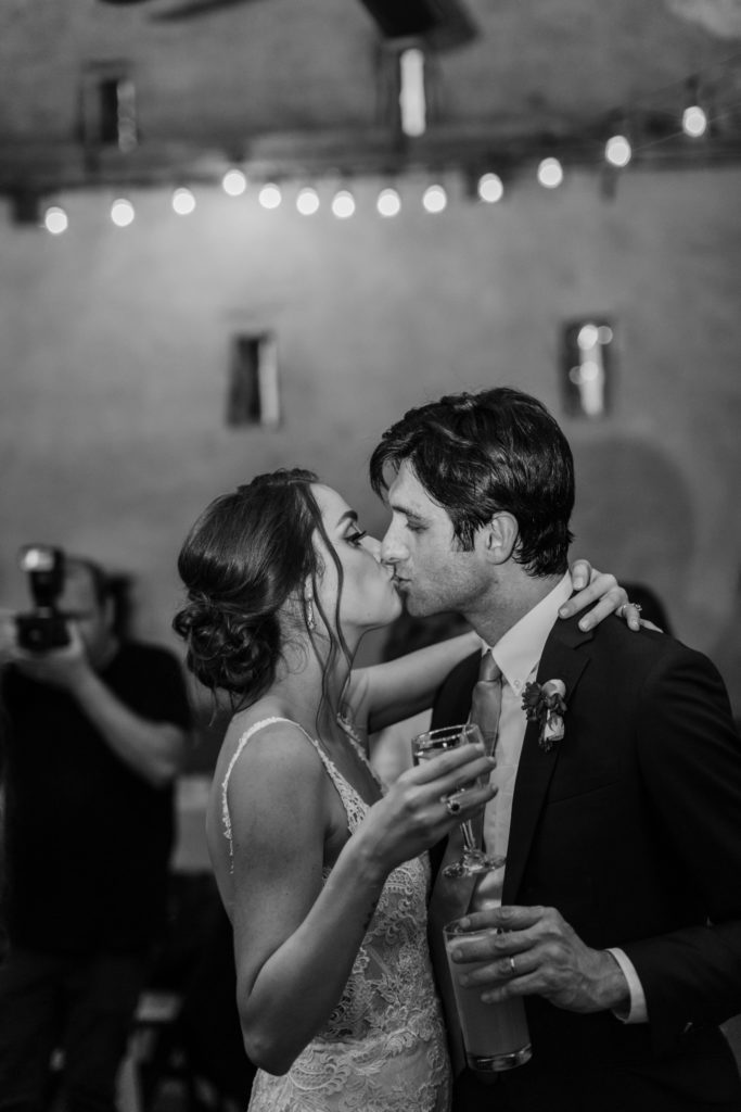 couple dancing and kissing at wedding reception