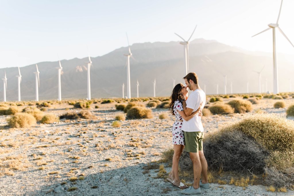 couple standing in desert for engagement session in palm springs