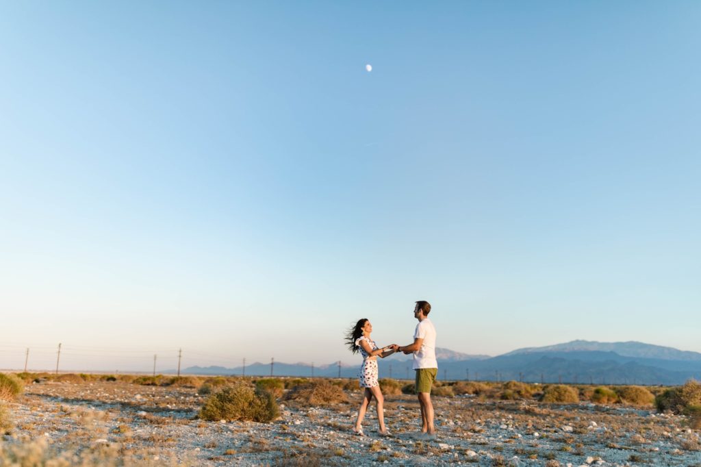 couple dancing in desert of palm springs by moon