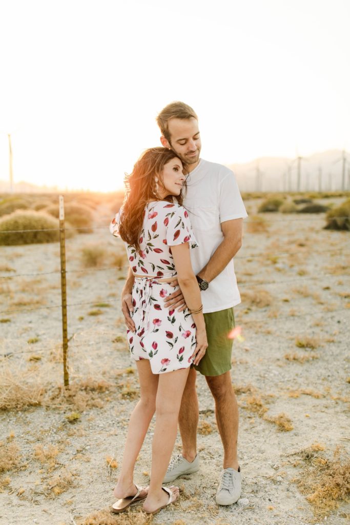 couple posing for engagement session photos in palm springs desert