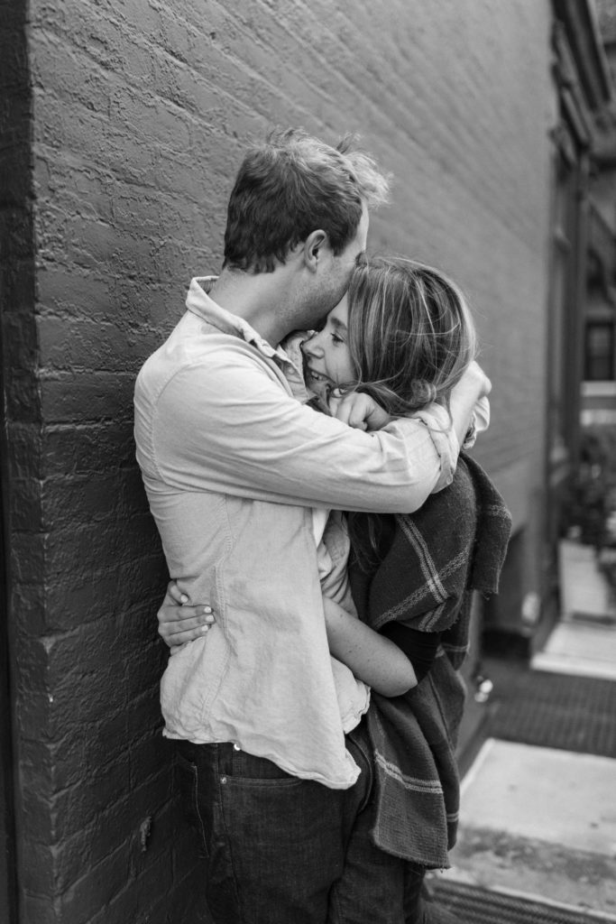 couple snuggling in nyc alley