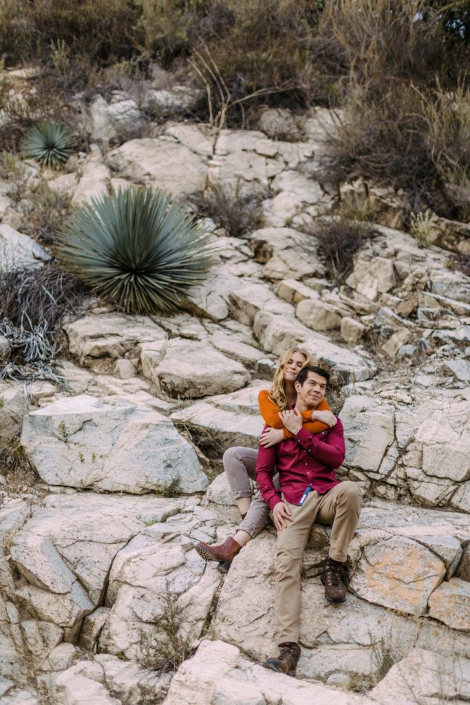 couple sitting on rocks in angeles national forest 