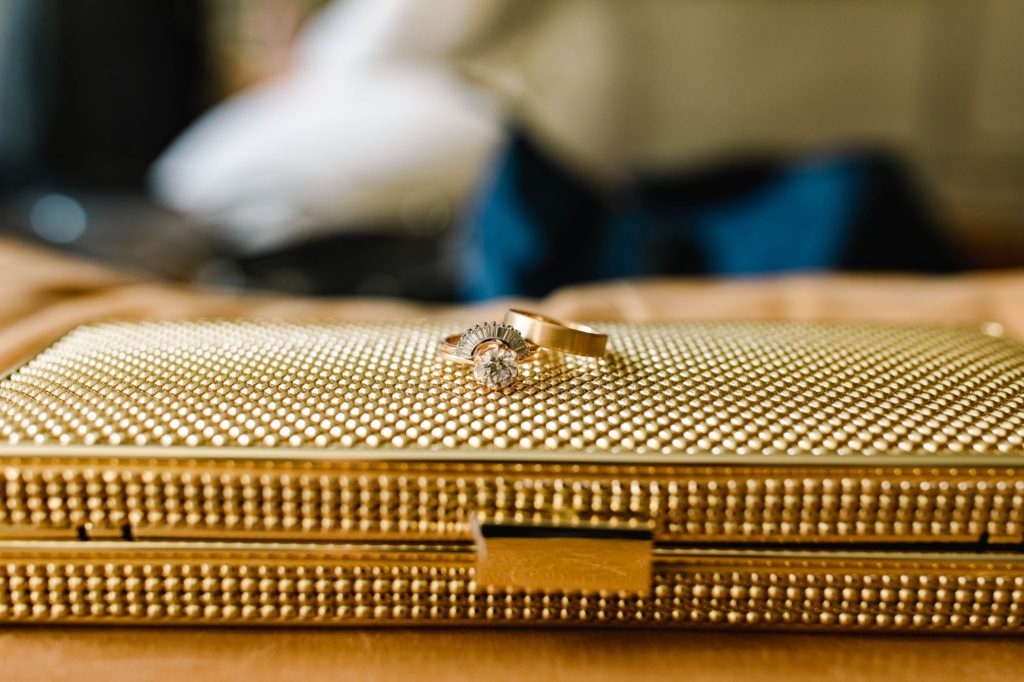 wedding rings on a gold clutch 