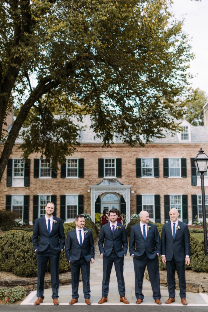 groomsmen stand in front of drumore estate 