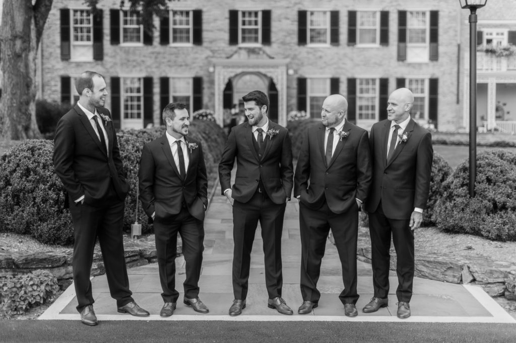 groomsmen stand in front of drumore estate 