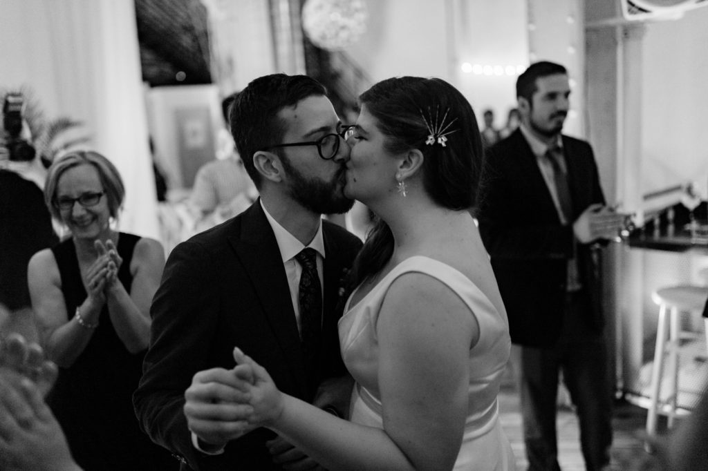 couple kissing at wedding reception
