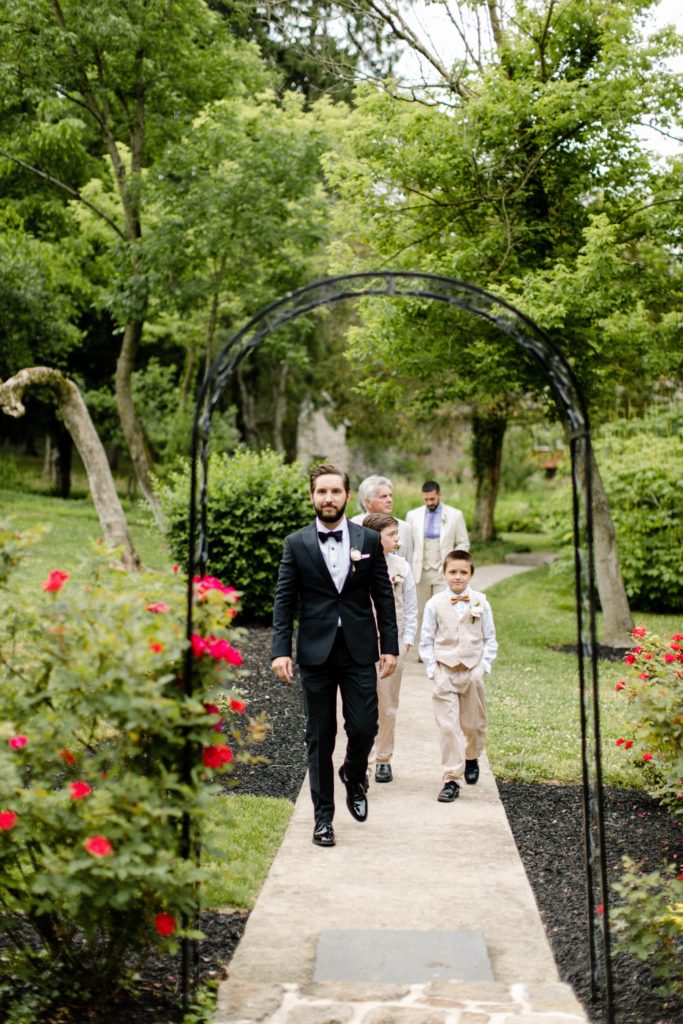 groom walking down isle at intimate wedding