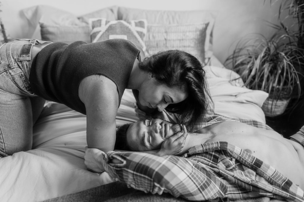 couple being sexy on bed during in home session