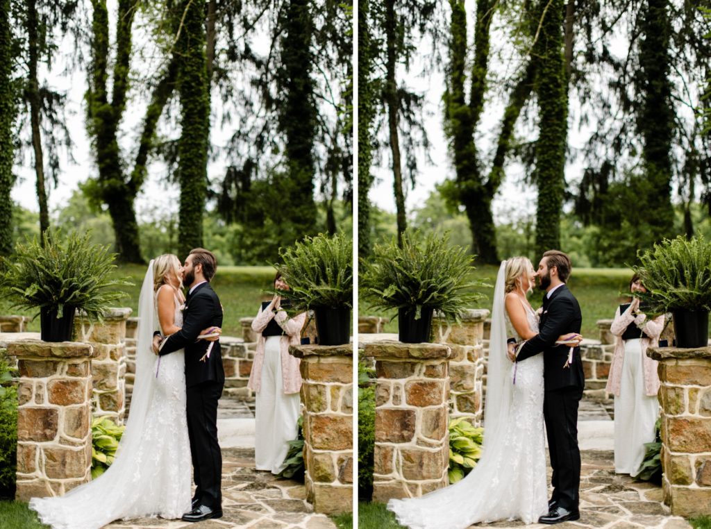 couple kisses at altar at intimate wedding