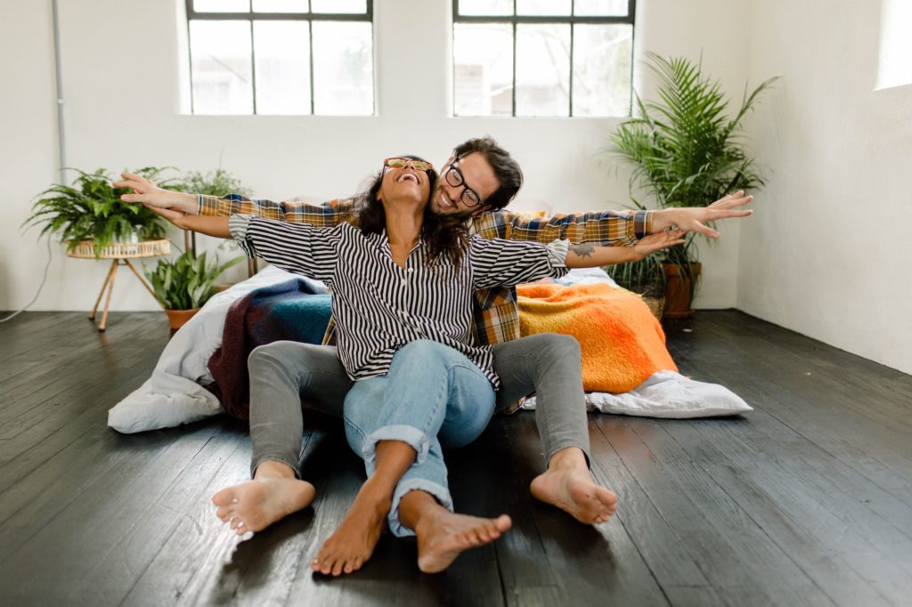 couple laughing on floor during in home session