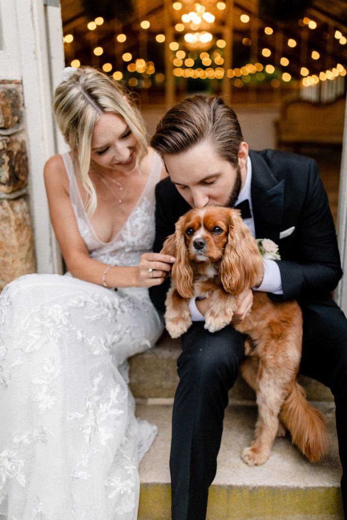 couple pose with dog for intimate wedding
