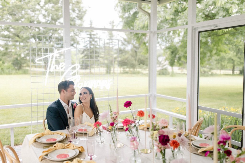 couple sitting at head table at intimate wedding