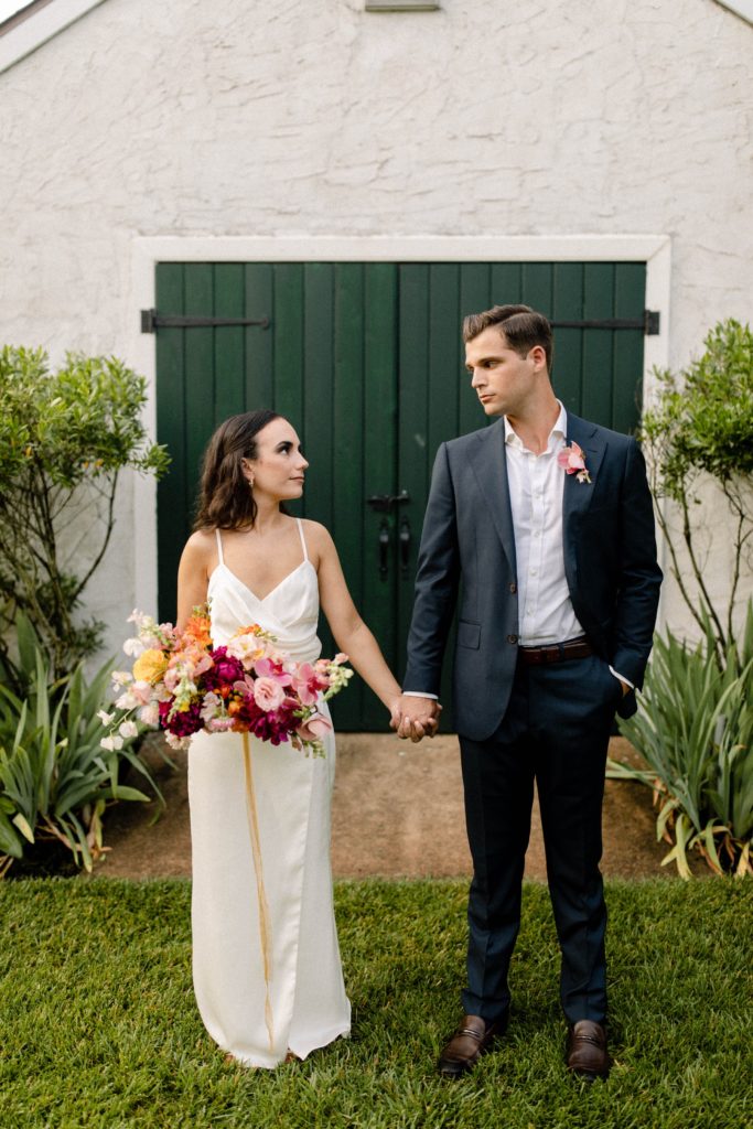 couple posing in backyard for intimate wedding 