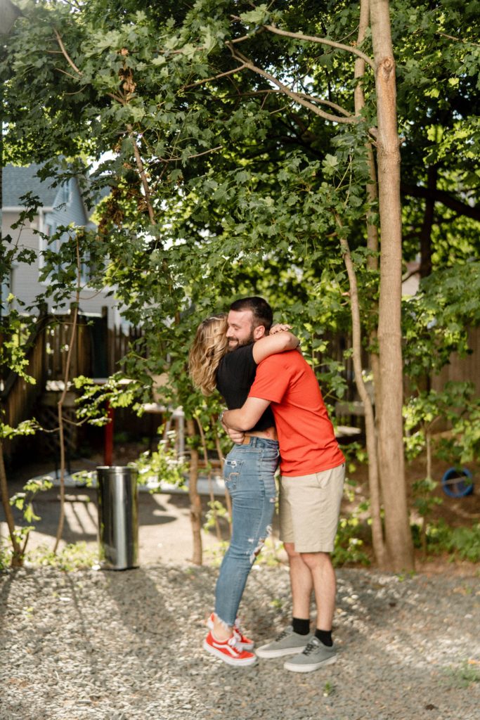 couple hugging in rutgers for engagement session