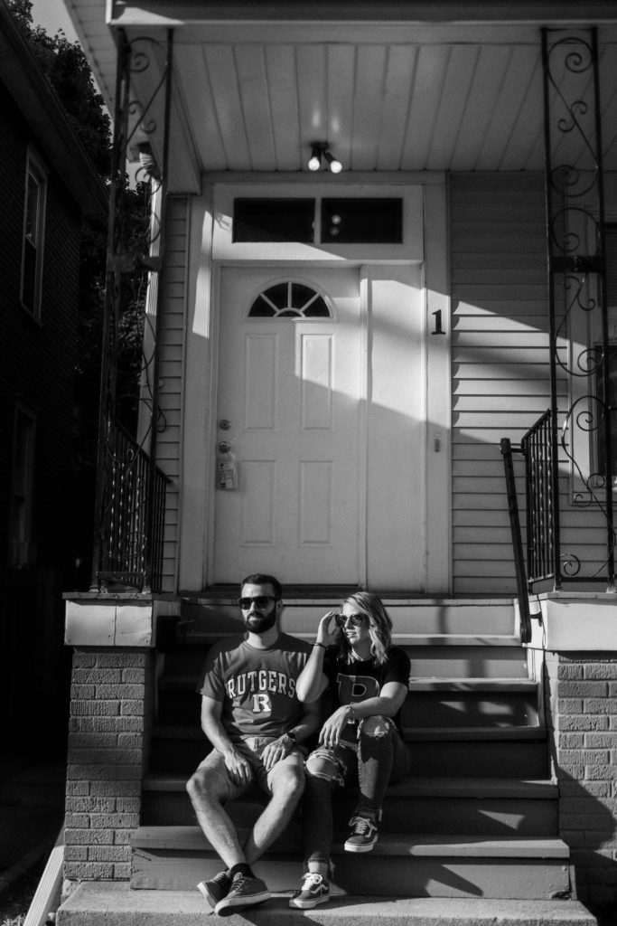 couple sitting on dorm step in rutgers for engagement session