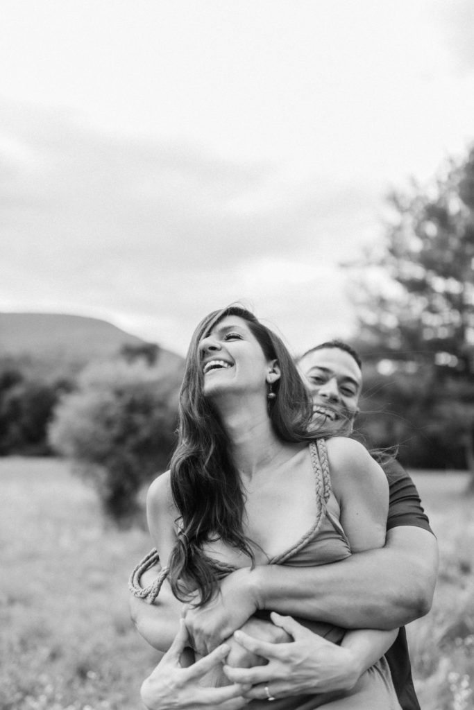 couple laughing in field in woodstock