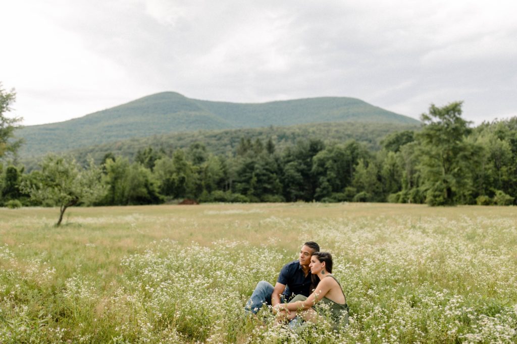 couple posing in flower field at woodstock engagement session