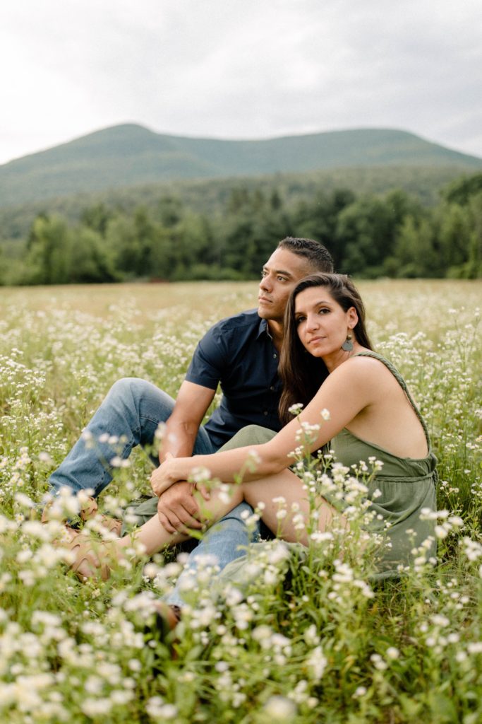 couple posing in flower field for engagement session