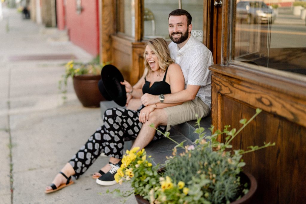 couple sitting on steps in rutgers for engagement session