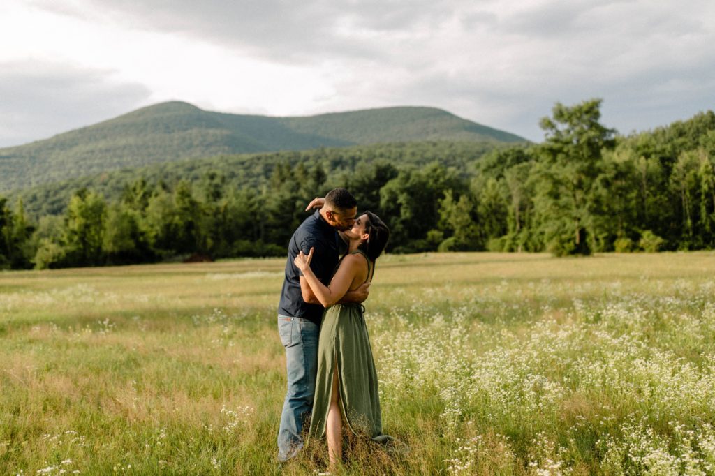 couple posing in front of mountain for engagement session