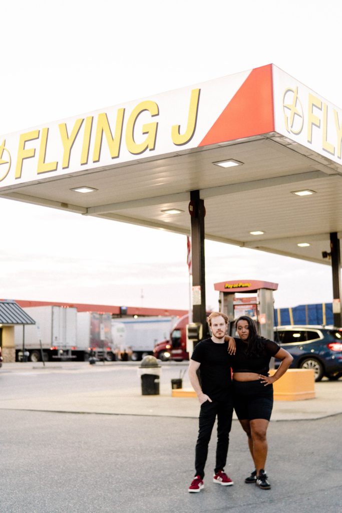couple posing for photos at truck stop