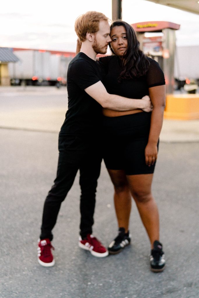 couple posing for photos at a truck stop