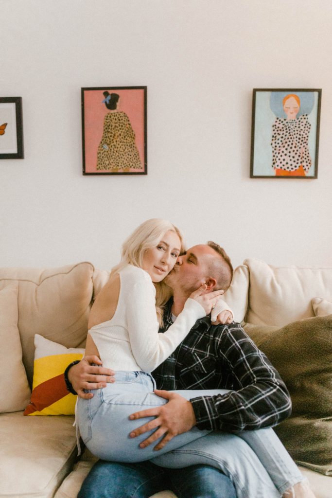 a couple snuggling for in home engagement session 
