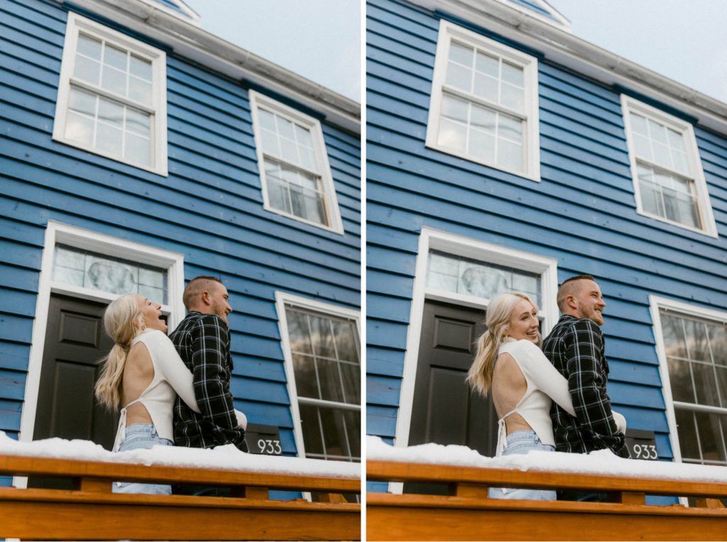 a girl hugs a guy in front of their home for winter engagement session 
