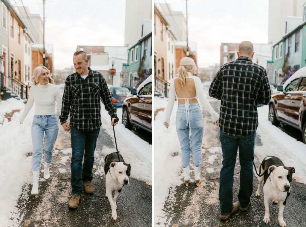 a couple walking down a snow covered street for engagement session 