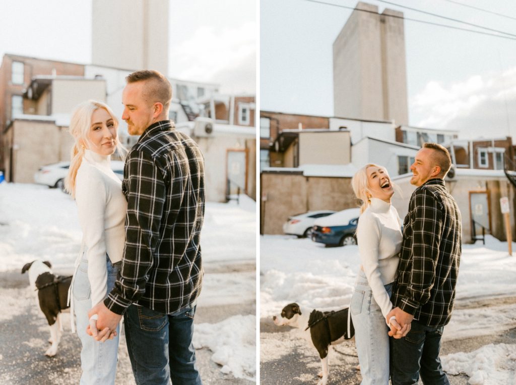 a couple posing on a snow covered street for engagement session 