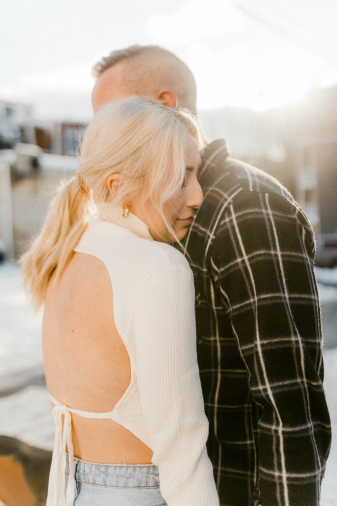 couple snuggles for winter engagement session 