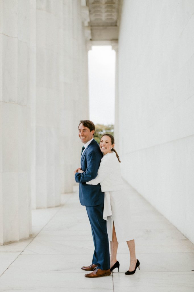 couple posing for photos at lincoln memorial