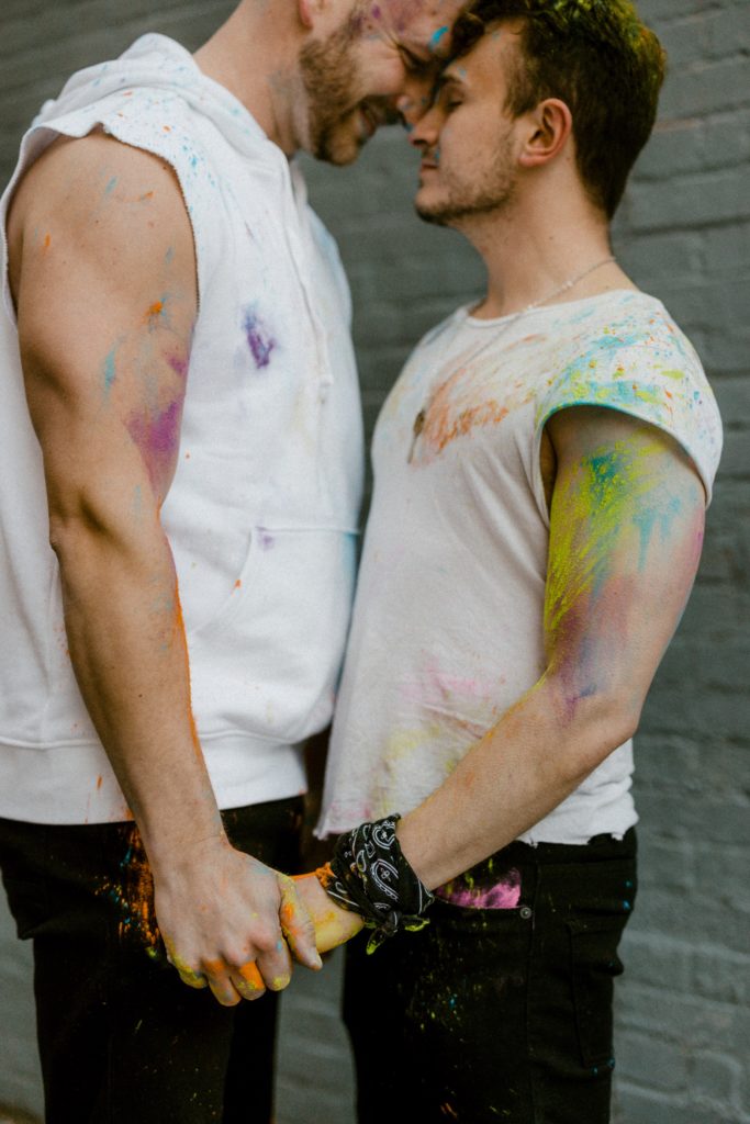 a couple holding hands in smoke bombs