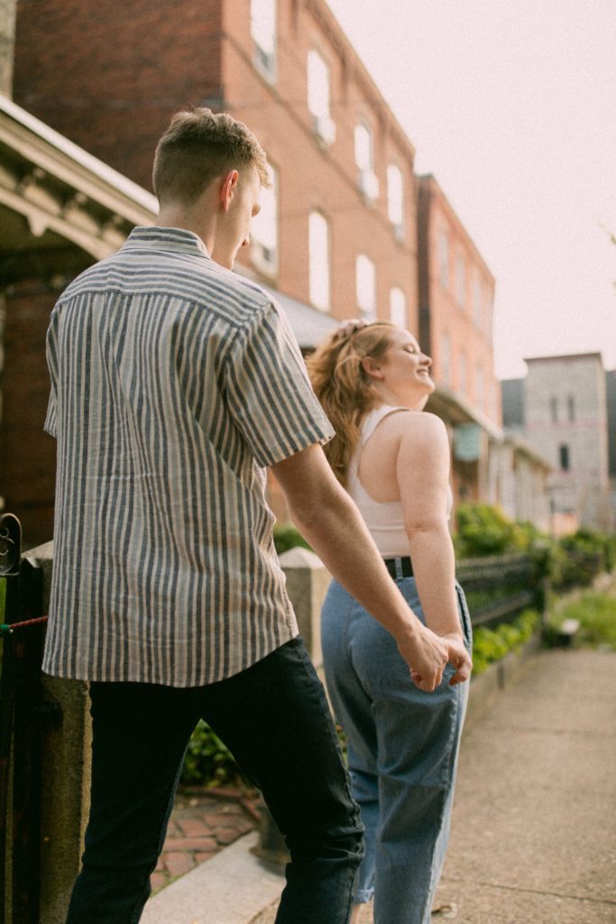 couple walking along philadelphia street for romantic philadelphia couples session