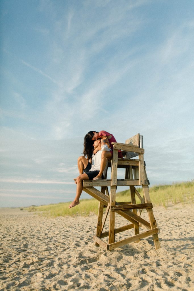 a couple snuggling on a lifeguard chair 