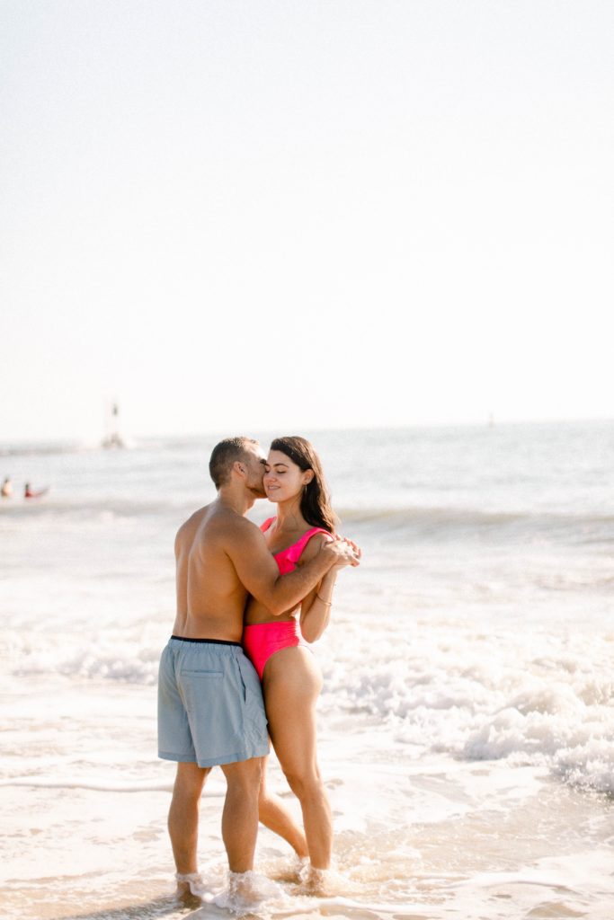 couple kissing closely on beach for sunrise rehoboth beach engagement session