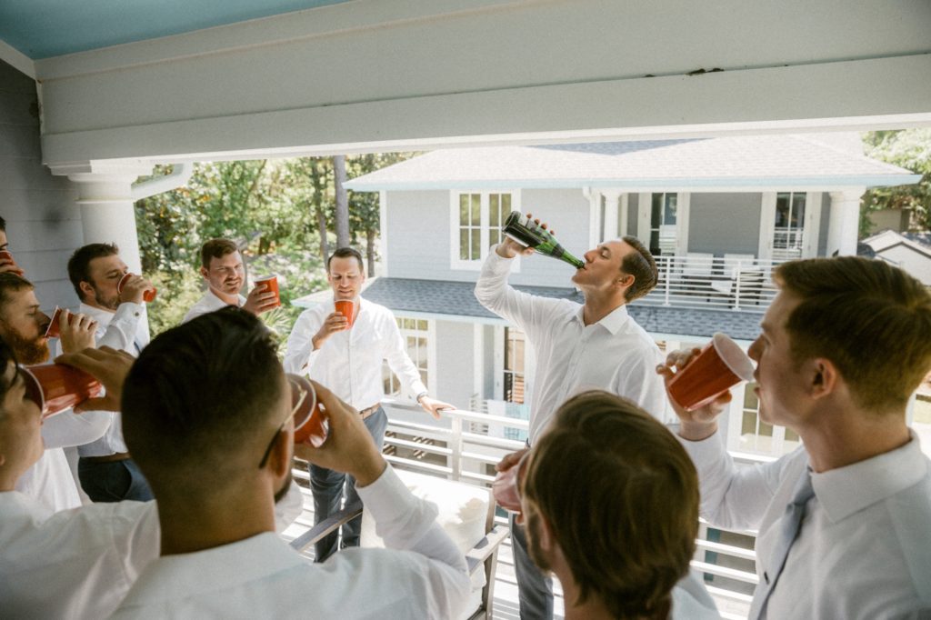 groom pops champagne with groomsmen for hilton head beach wedding