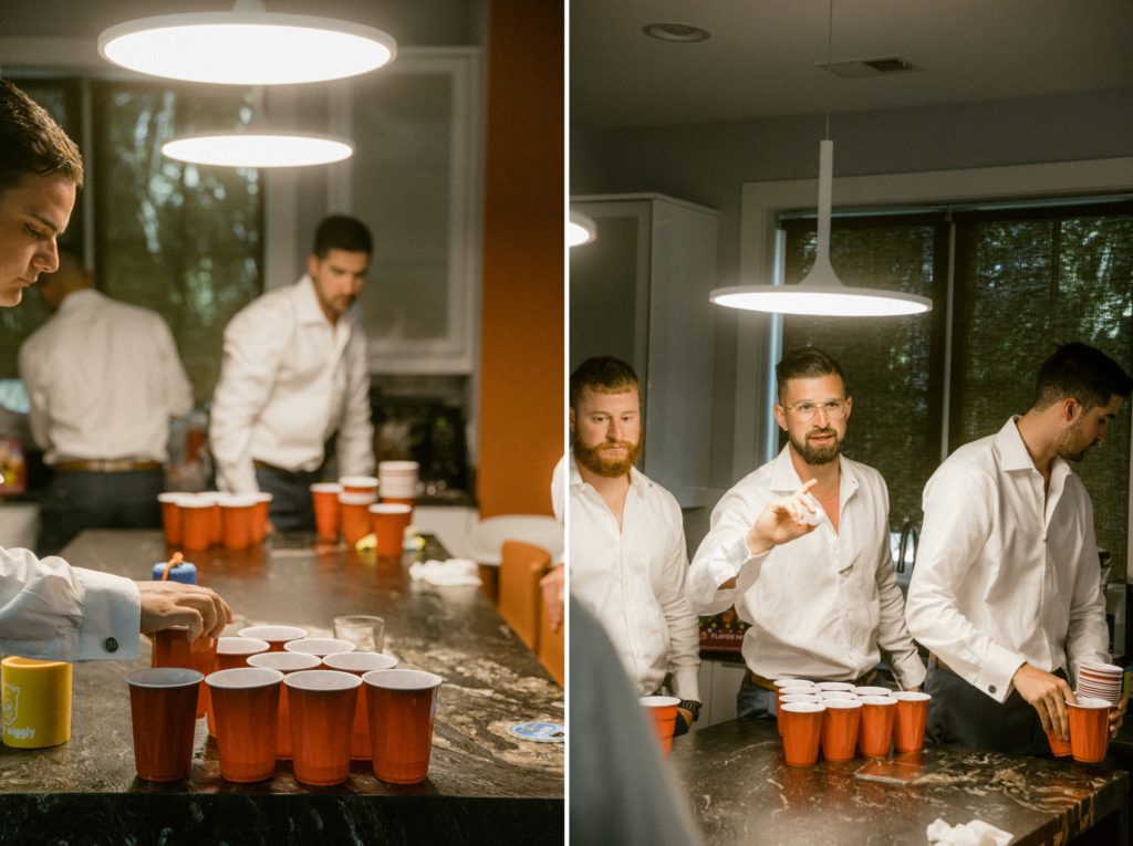 groomsmen play beer pong while getting ready for wedding 