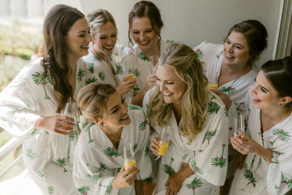 bride and bridesmaids cheers mimosas at hilton head beach wedding