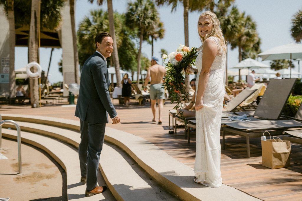 bride and groom walk by pool for hilton head beach wedding