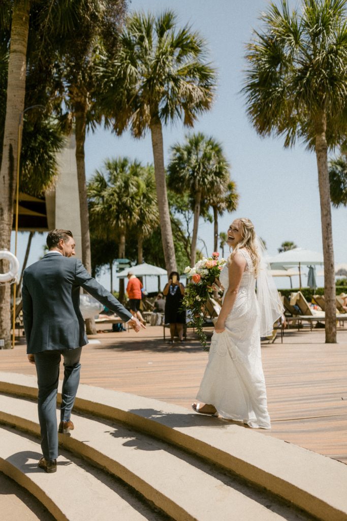 bride and groom walk by pool at hilton head beach wedding