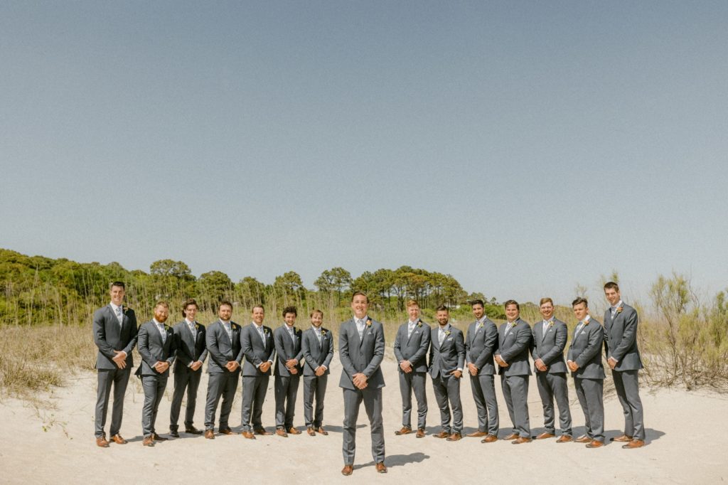 groomsmen pose for photos at hilton head beach wedding