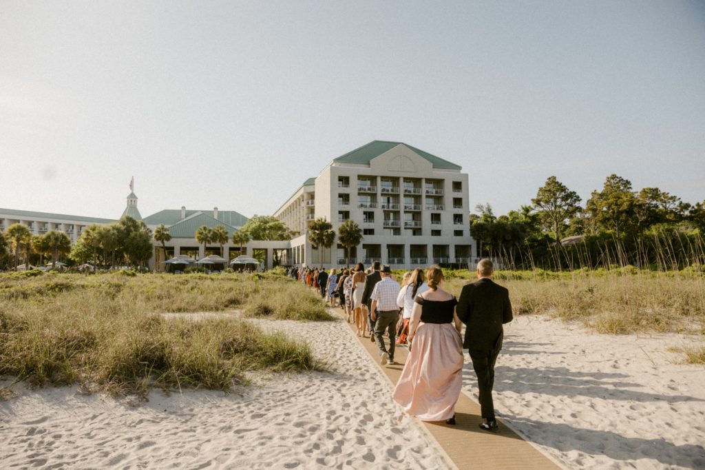 guests walk to cocktail hour for hilton head beach wedding
